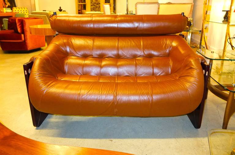 Leather and Jatobah wood finished as rosewood loveseat sofa by Percival Laver, Brazil, 1972.

 
