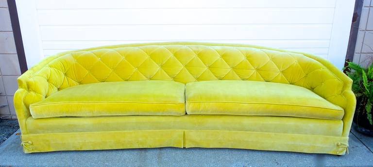Very stylish vintage sofa by Tomlinson very much in the style of Dorothy Draper with split seat cushions, curved back, sculpted arms, diamond tufts and box-pleated skirt with buttons.  

This sofa is very clean with only a few spots (see detail