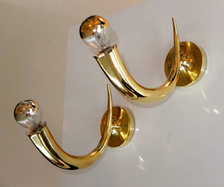 Superbly crafted 'horn of plenty' sconces with curved brass horns, slightly scalloped edges and round backplates.

Each sconce takes a single candelabra size bulb up to 60 watts each.

Shown here with gold mirror crown bulbs.

Very much in the