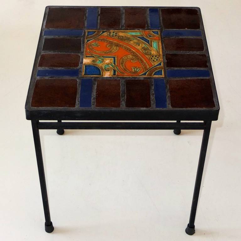 Modern square occasional table made from slim blackened iron square bar the top of which is inset with glazed ceramic and earthenware tile, the center square of which appears to be a paisley design.