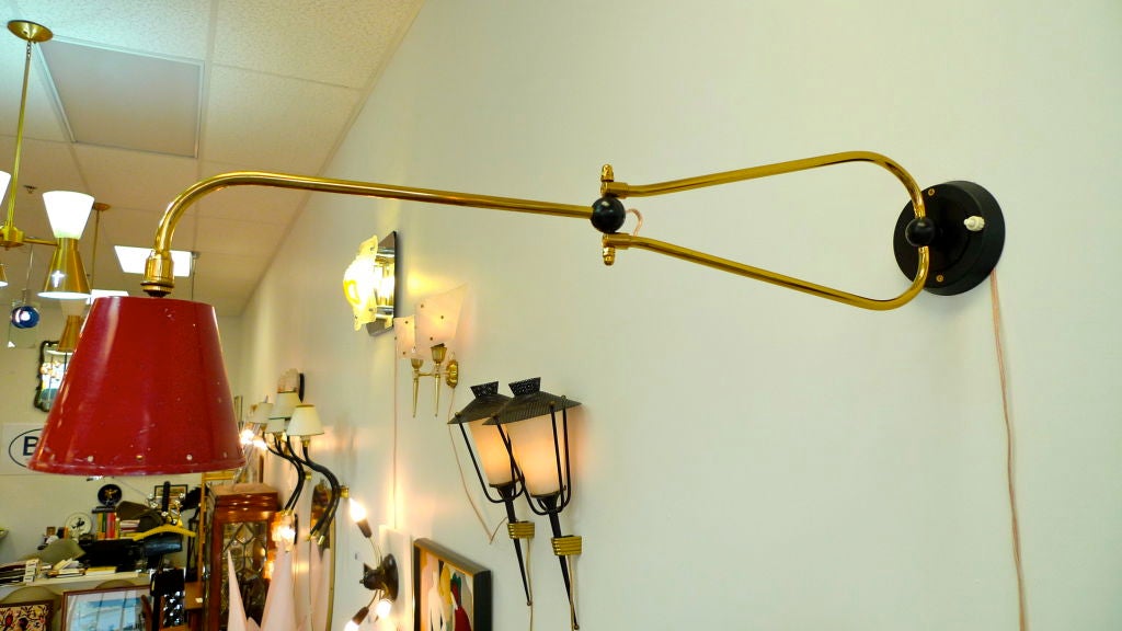 Delightful vintage French 1950's swing arm sconce with articulating enameled aluminum shade and brass arm which swings on an ebonized ball.  
On/off switch on wall plate. Custom back plate to fit your j-box available. In the manner of Jacques Biny.