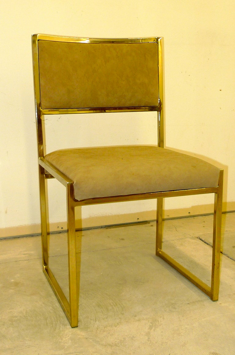 Set of six dining chairs attributed to Milo Baughman for Design Institute America (DIA).  Square design with upholstered seat and slightly curved raised upholstered back.  Brass finished frame is in excellent condition. Original taupe suede