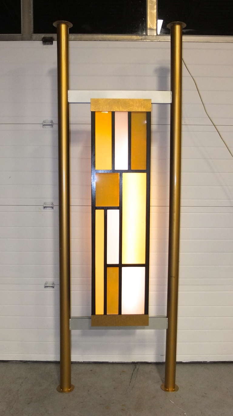 Fantastic floor to ceiling partitions or room dividers with double-sided colored acrylic light boxes.

Vertical poles are steel which has been enameled gold..

Light box cases are wood and acrylic with metal laminate embellishments.

Same design on