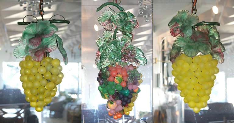 Pendant light cluster of three bunches of grapes….a pair of green grapes and a single bunch of multi-colored grapes in various stages of ripening, embellished with other vine fruits.

Each grape cluster hangs independently from a painted iron