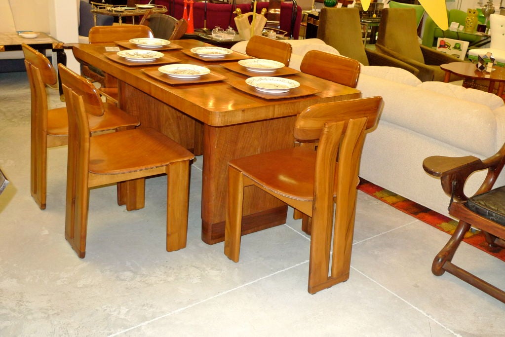 Set of six robust Italian dining chairs with saddle-stitched leather seats, cognac colored.

Very comfortable even for larger sitters despite the slim profile.

