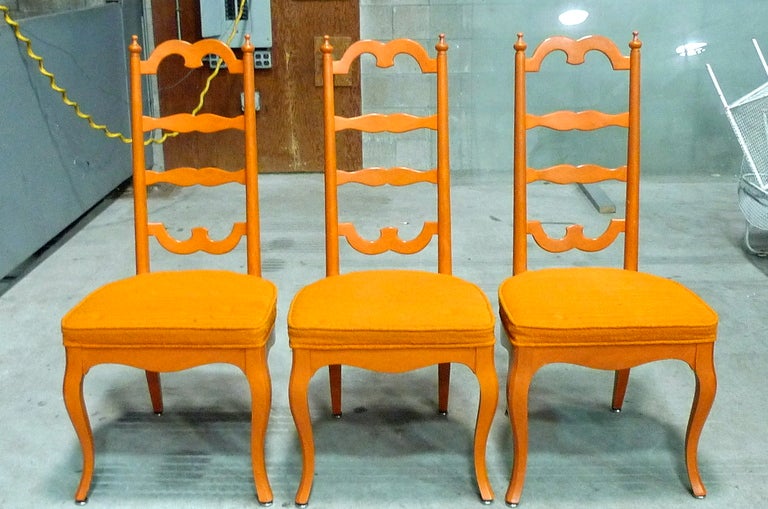 Whimsical set of six dining chairs in vibrant orange by noted modernist designer Noel F. Birns.