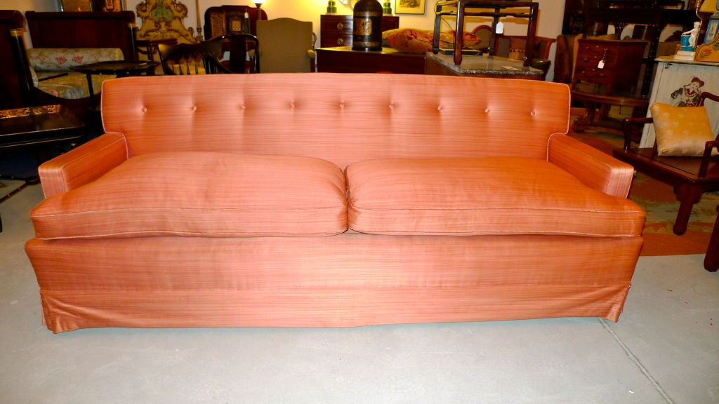 Immaculate mid-1960's down filled sofa by Baker upholstered in peach striated silk.

I am tempted to remove the skirt to show off the walnut legs and make it a bit more modern looking but I will leave that up to its new owner.