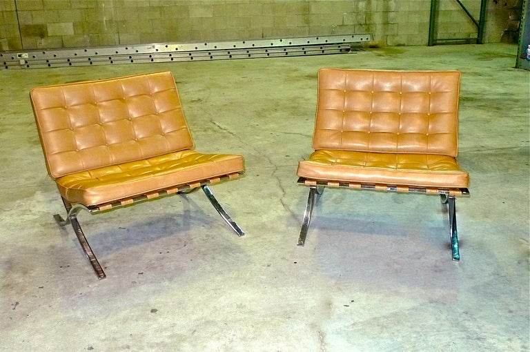 Pair of Barcelona chairs after Mies van der Rohe with light brown faux leather tufted seat cushions on iconic chromed steel X frame.  Unmarked but most likely imported by Stendig, circa mid-1970's, and produced in Italy.