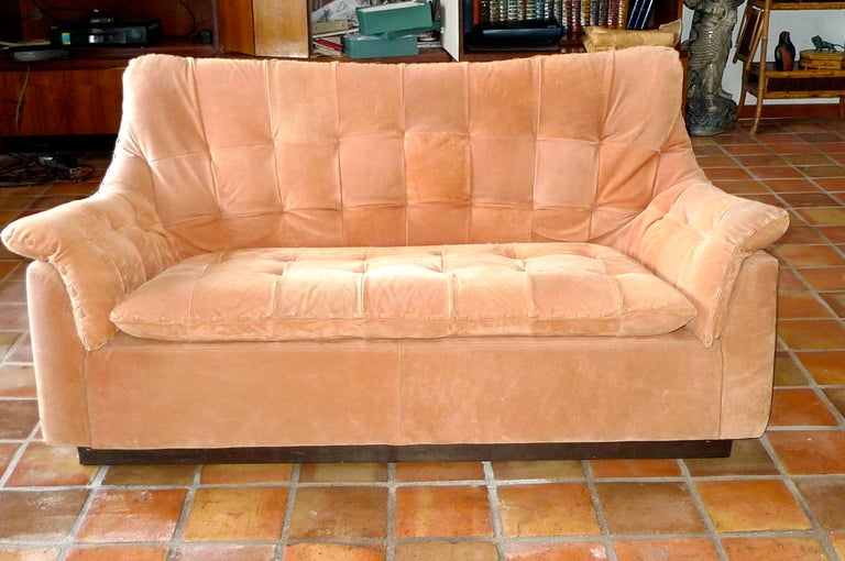 Pair of handsome sofas with attached tufted cushions (seat, back and sides) covered in rustic deerskin with 