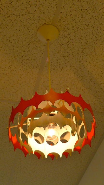 Concentric rings of painted metal with bat wing scalloped edges, produced in Bavaria by Doria. Casts great shadows on the ceiling. Holds one central bulb.  Can be as high as 200 watts if you desire. White cord can be shortened or lengthened by