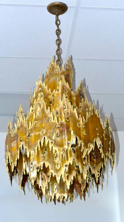 Oversized and brutal, this hand crafted chandelier evokes mineral formations in underground caves. By T. A. Greene for Monteverdi & Young or Feldman Lighting.