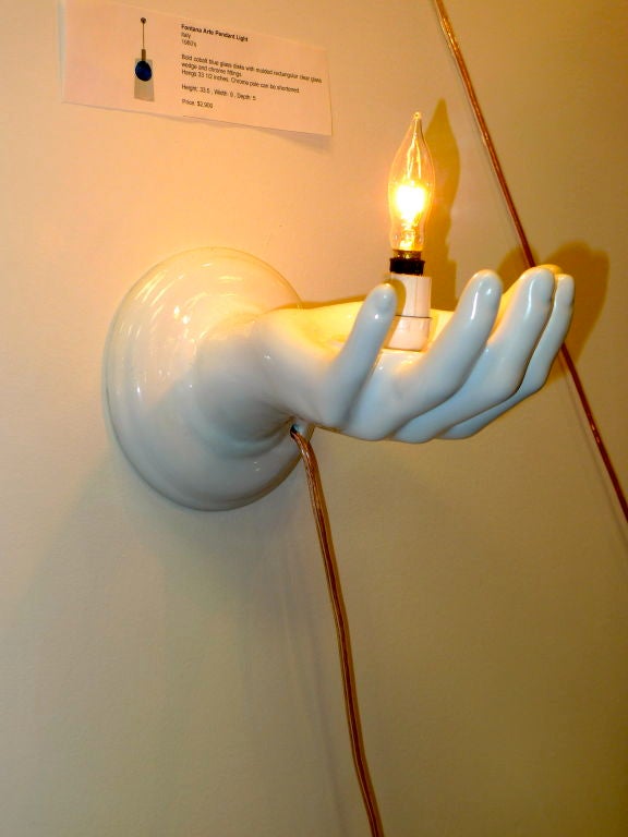 Italian ceramic sconce in form of palm up open hand with single candle socket in the palm.