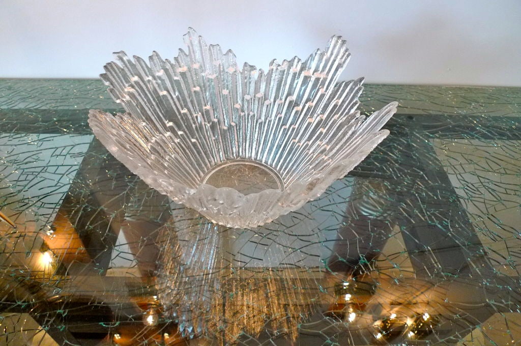 Chic and stylish molded glass bowl with starburst / sunburst beams radiating up and out from the center.  <br />
<br />
Very sculptural jagged edge design. Could also be described as having the form of icicles or a snowflake.<br />
<br