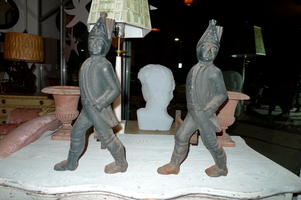 Pair of cast iron fireplace andirons in the form of Hessian soldiers.

The Hessians were German mercenary soldiers hired by the British Crown to fight with the Loyalists against the Patriots in the American War of Independence. They landed at