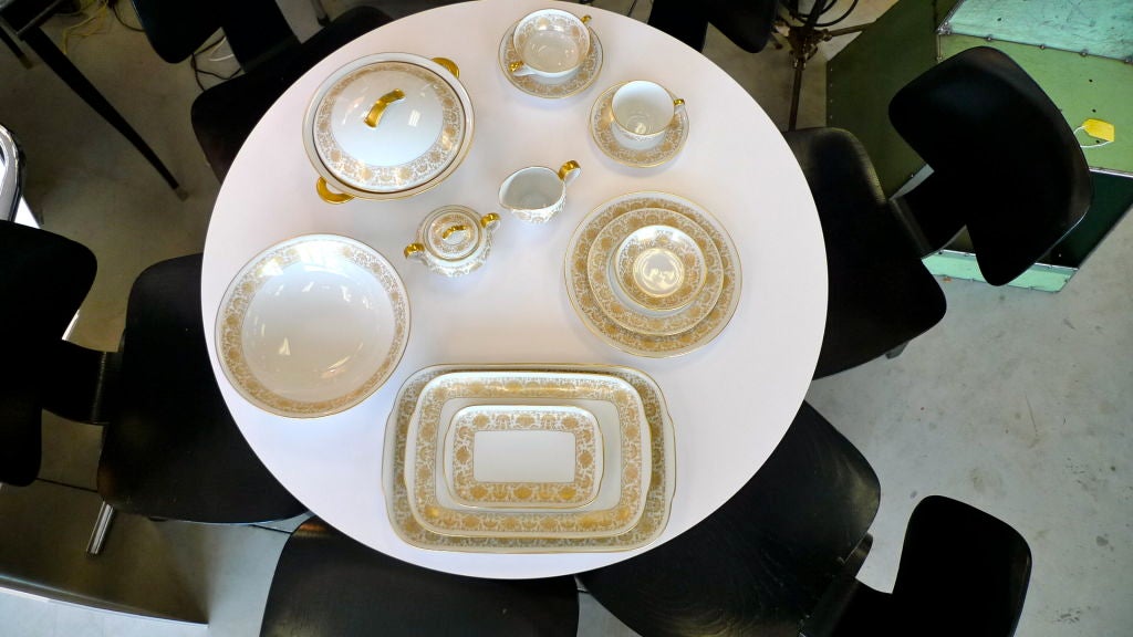 An immaculate and complete set of vintage German porcelain service for 12 including multiple serving pieces; tureen with lid, large bowl, three platters, creamer and sugar, bouillon cups, etc. Shown in photos are all pieces including one dinner