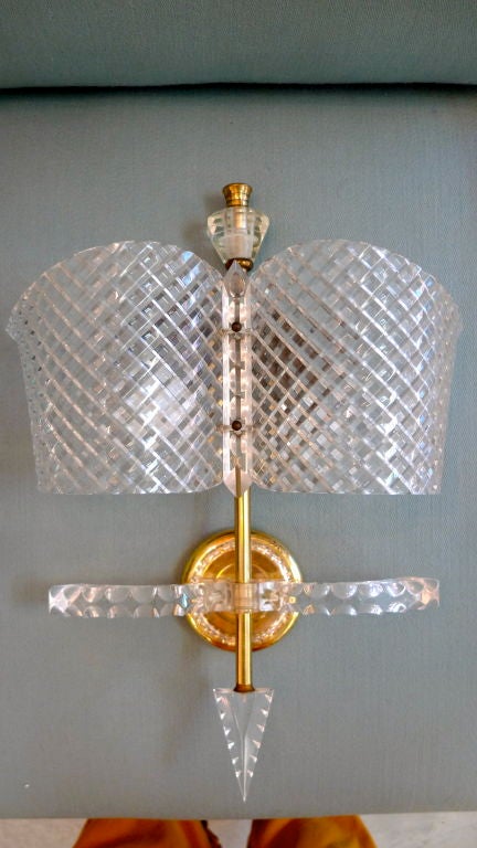 The French in the late 1940s and early 50's were very adventuresome with new plastics and plexiglass and Lucite.  This enchanting wall light has such intricate detail that it almost fools the eye into believing it is actually shaped and faceted