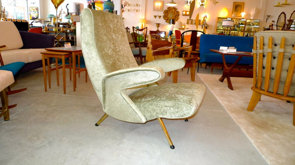 Feel hugged in this anthropomorphic and ergonomically designed Italian arm chair from the 1950;similar in design to Erberto Carboni's Delfino Chair for Arflex, 1954.<br />
<br />
Newly upholstered in shimmering pale green velvet.<br />
<br