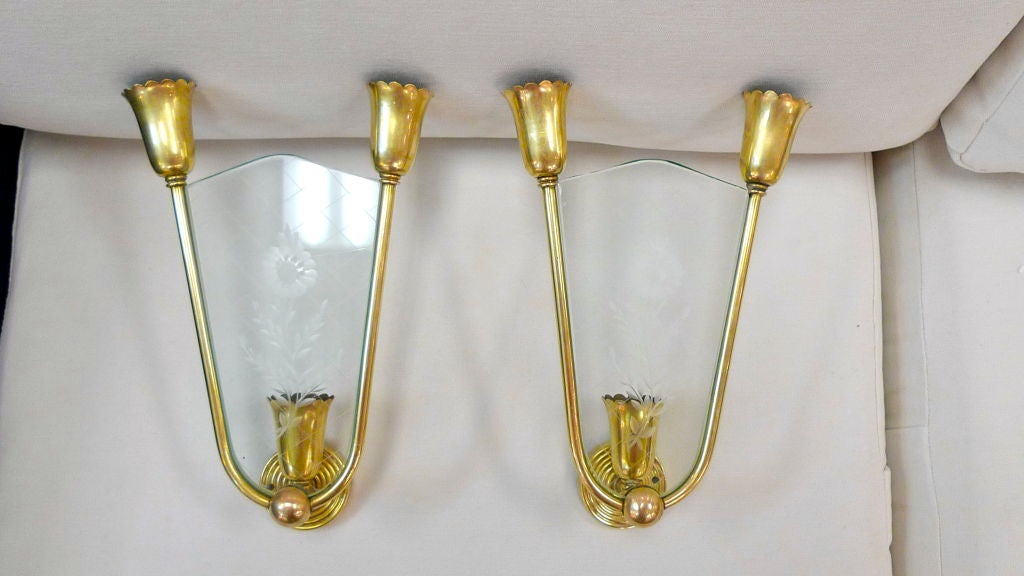 Elegant pair of Italian sconces from the early 1950's in the style of Pietro Chiesa for Fontana Arte. Each sconce takes three candle bulbs.<br />
<br />
These are chic and absolutely wonderful.  The clear glass shield is not only engraved with a