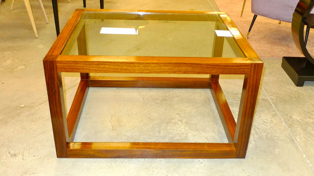 From the Mercer Street Collection of Ralph Lauren Home, this vintage cocktail table is as clean as it gets.  Rosewood on mahogany.  Original glass. 40x36x18.  Simple geometric shape.