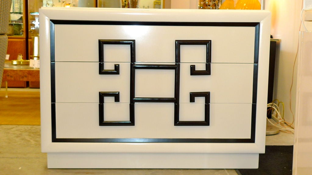 Fabulous over-sized chest of drawers/dresser by Kittinger from their earliest Mandarin collection with bold Greek Key drawer handles.  Newly refinished in high gloss enamel white lacquer with black trim. Platform base.  Original Kittinger paper