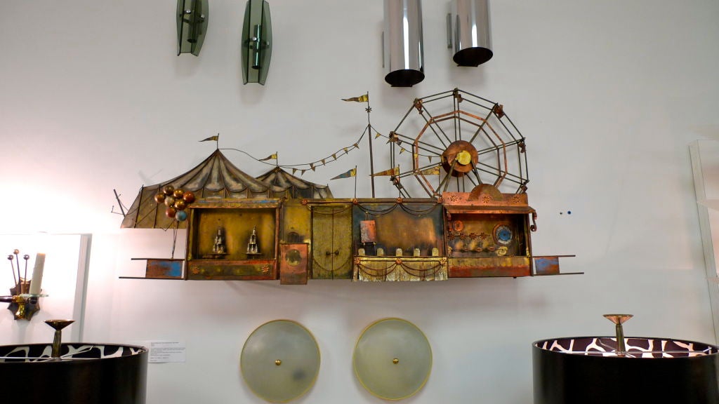 This is an early example of the fine metal craft done in the name of C. Jere (Curtis Freiler and Jerry Fels) for Artisan House.  <br />
<br />
Note, this piece can either stand on a table or hang on a wall.<br />
<br />
Scene depicts a carnival
