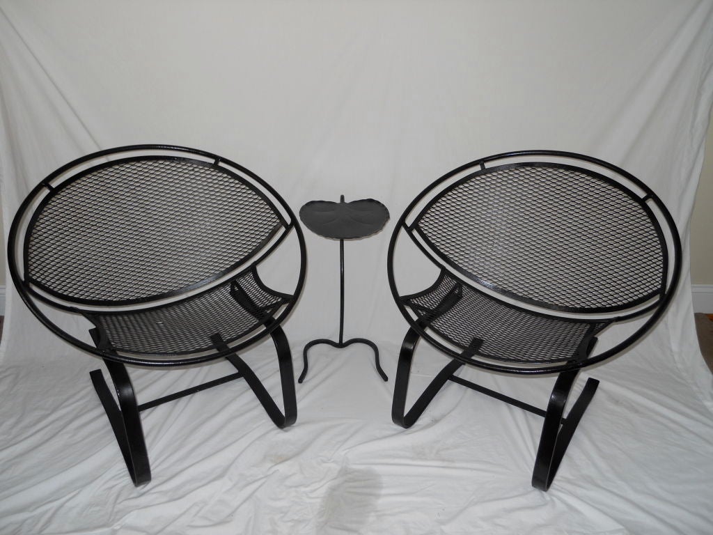 Wonderful pair of vintage Salterini cantilevered spring bounce rocking chairs.<br />
<br />
Price is for the pair; not sold individually.<br />
<br />
Shown with one of two Salterini Lilly Pad iron side tables (see separate listings for more