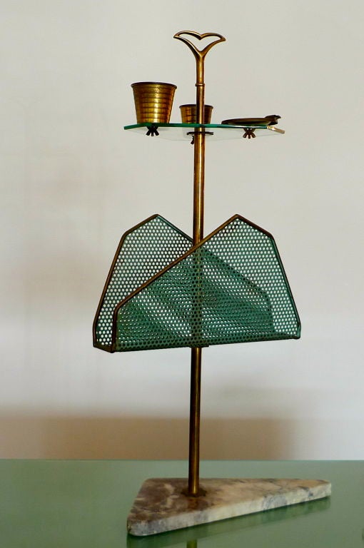 Incredibly chic and sculptural Italian 1950's floor stand for holding your magazines and newspapers, an ashtray and your favorite tipple.