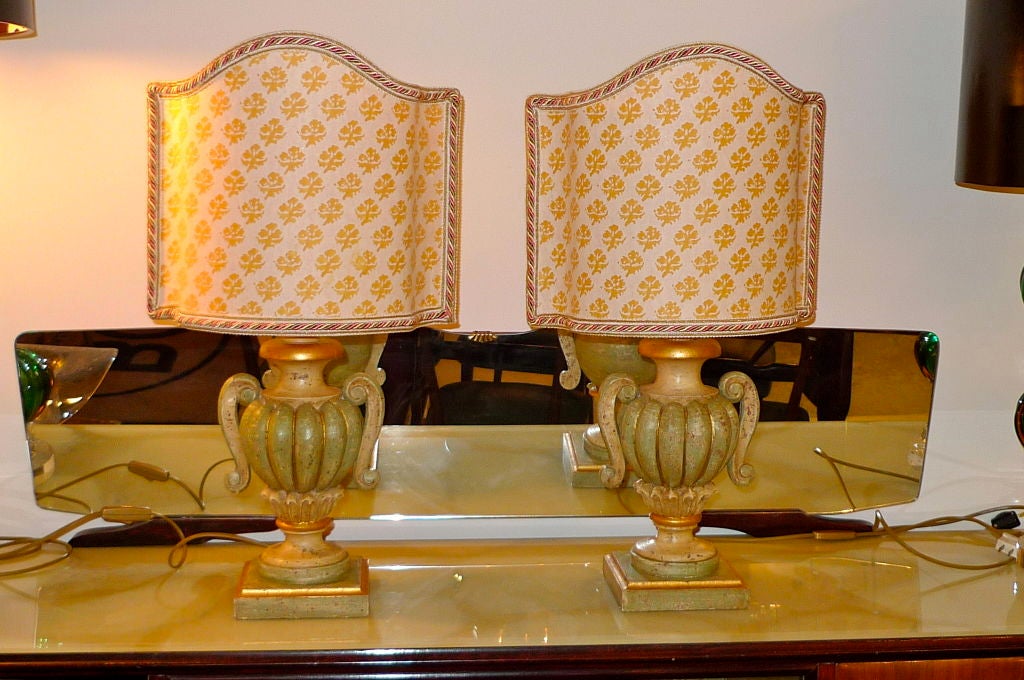 Pair of carved wood poly-chromed table lamps with hand-made Fortuny shield-shape shades from the Greco Studios of Venice. A favorite of Syrie Maugham.
Price is for the pair.