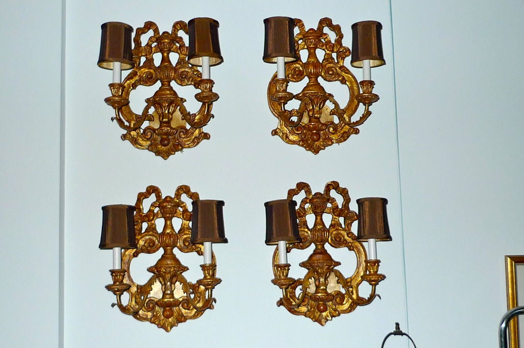 Carved gilt wood ribbon sconces / candelabra by Fratelli Paoletti of Firenze.<br />
<br />
Back plate mounts over a standard junction box.<br />
<br />
Can also be sold in pairs for $2400.