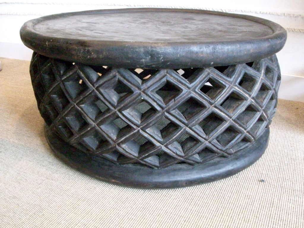 Round, carved wood, African coffee table.  Very unusual piece at this large size.  Slight lip around the edges of the top as shown in the photos.