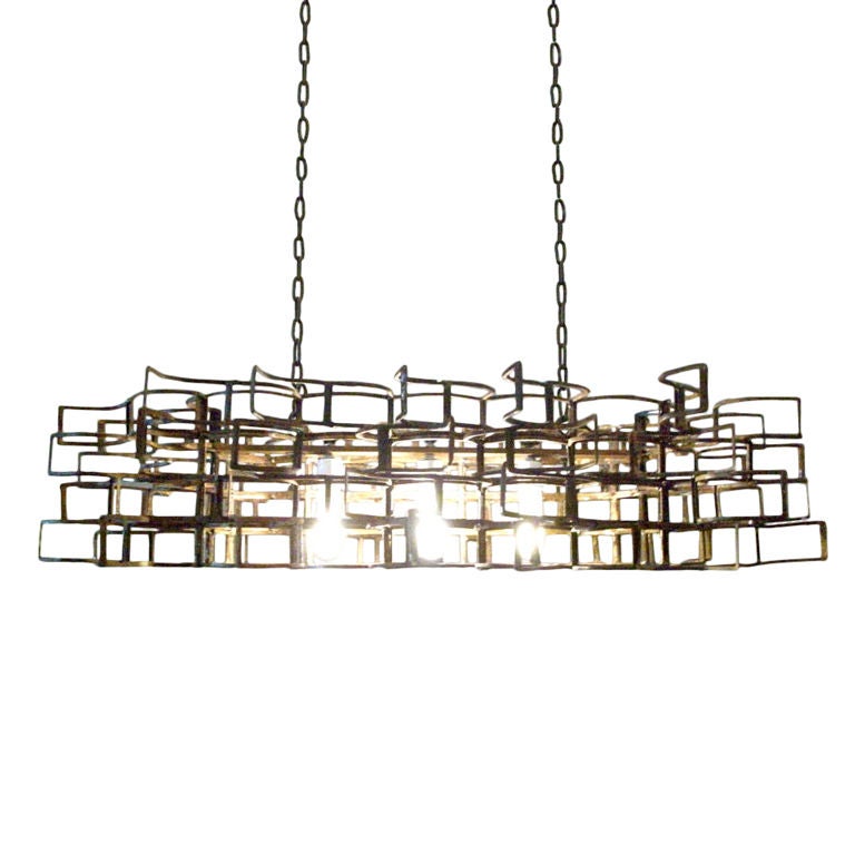 This piece is a welded salvaged metal light fixture by sculptor and artist, Lucy Slivinski. It is rectangular in shape and hangs as a chandelier. It accommodates 3 bulbs and includes two standard 4' chains or rods for hanging.
Available finishes