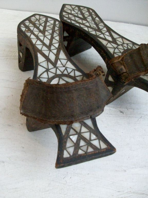 This pair of Nalin - or Turkish bath clogs are from the Ottoman Empire when people went to the public bath houses or Hammam.  The purpose of the elevated platform design is to keep one's feet above the soapy or dirty water on the floors.  The bath