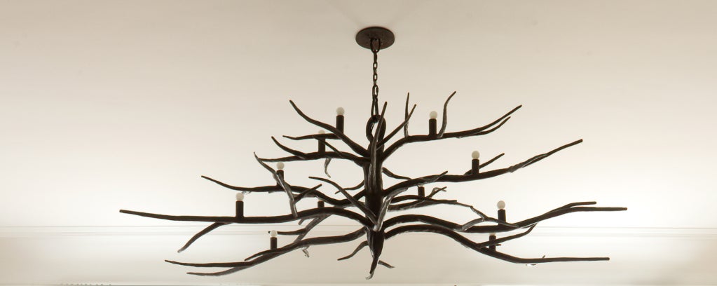 Custom hand-forged iron Branch chandelier by Michael Del Piero. 
Inspired by a love of the naked trees of winter, Michael has designed a branch shaped, hand-forged iron chandelier. The irregular organic shape and beautiful patina make this piece a