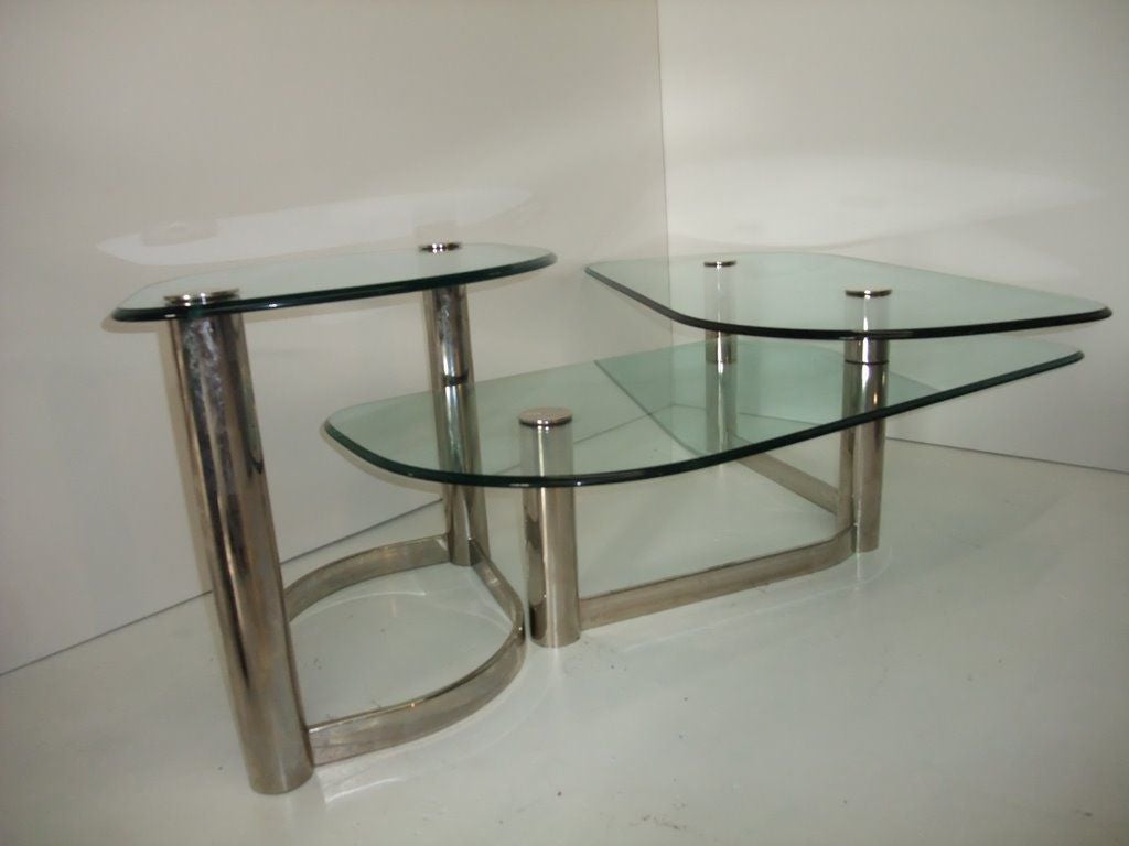 Sophistiquated and movemented 3 levels tops, coffee tables.The complete set Can be separated in two parts . One single one and two attached .   The two different parts can also be set up alltogether in one position. the glass tops are thick glass