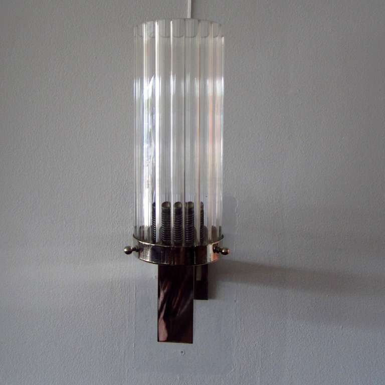 Grooved Tubes of pure cristal supported by a round chrome circular part .
Very interesting refined wall lights.