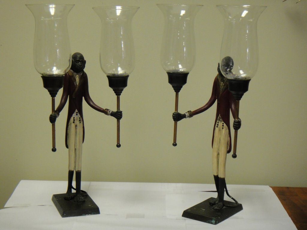 PAIR OF BRONZE PAINTED CANDEL  HOLDERS.
Monkeys dressed up as a valet carring candels.