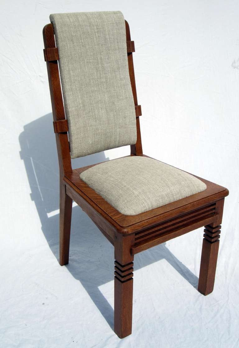 High quality chairs designed by Charles Dudouyt. 
Architectural and geometrical moldings.
Refined and sophisticated details.
Extremely modern conception for this period with rigorous lines. 
Quality golden oak.