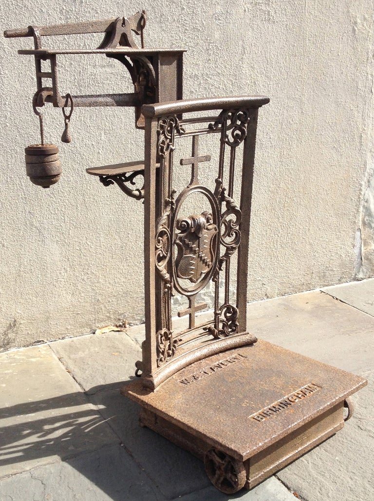 A large 19th century English cast iron scale, circa 1840, marked Birmingham, England and features scrolling decorative and organic elements. It was purchased in the U.S. and would have been used for measuring the weight of agriculture like cotton.