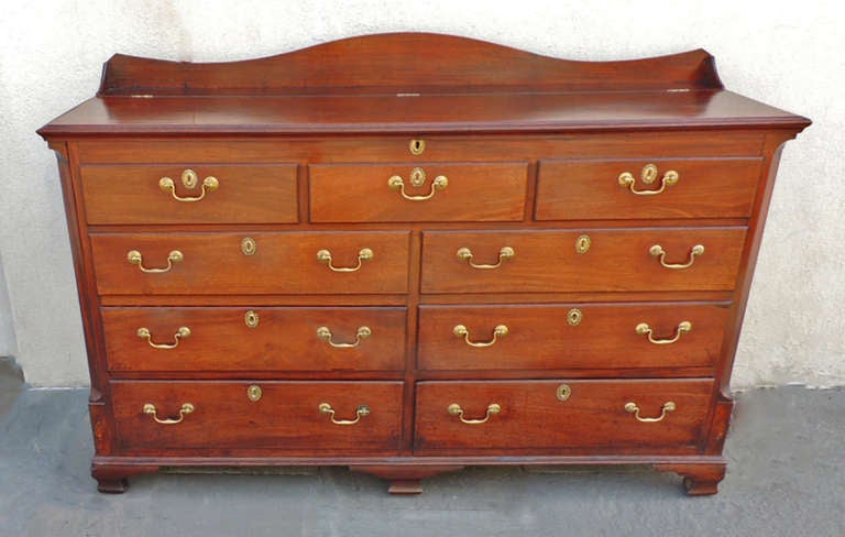 This piece was made in the early half of the 19th century in England. This piece is made of solid mahogany and has it's original handles. The top section lifts to revel a inner cupboard that measures about 17 inches deep. This inside section can be