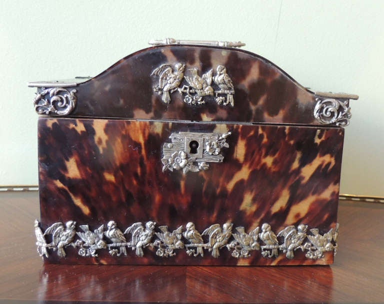 This music box was made in France during the 18th Century and is made of natural tortoise shell. The decoration on the top and sides of the piece are sterling silver. The entire bottom is lined with birds and this exact design is featured on the top