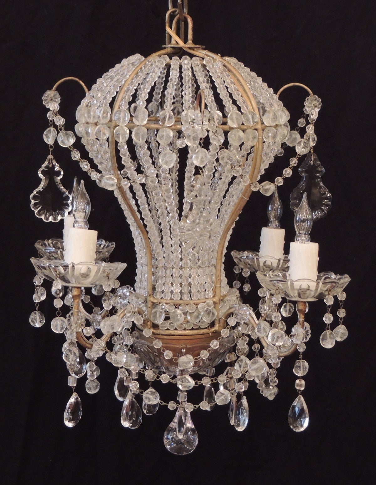This chandelier was made in Italy during the first half of the 20th century, circa 1920, and is in the shape of a hot air balloon with four lights. The top section features crystal and rock swag hanging outside the top of the balloon with four