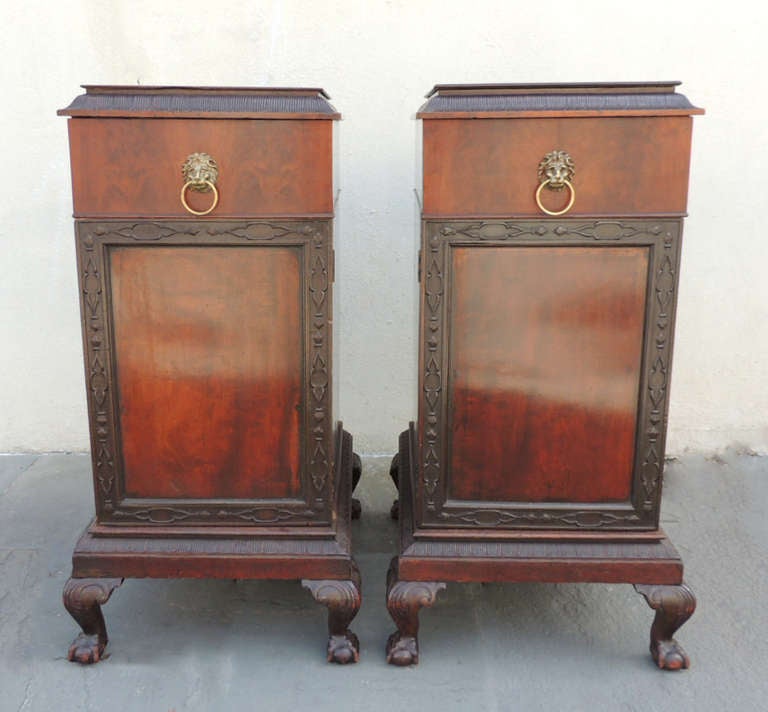 This pair of pedestals/cabinets were created in 1800 and made of mahogany.  Each of the pieces have lions head pulls on the top drawer. Both pieces have a bottom section; however, one contains cellerate drawer and the other linen drawers. 
The