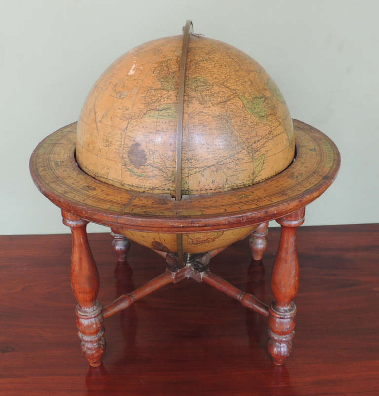 This American globe was made in Boston in the first half of the 19th century. This piece was crafted by Gilman Joslin, a famous globe maker and woodworker residing in Boston in the 19th century. The stand and paper cover are original to the globe.