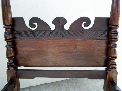 A striking Caribbean bed that exhibits most of the best formal and vernacular elements of furniture from the West Indies. The headboard bolts to the headposts, which is unique to Jamaican beds. This feature allows one to enjoy the full relief of the