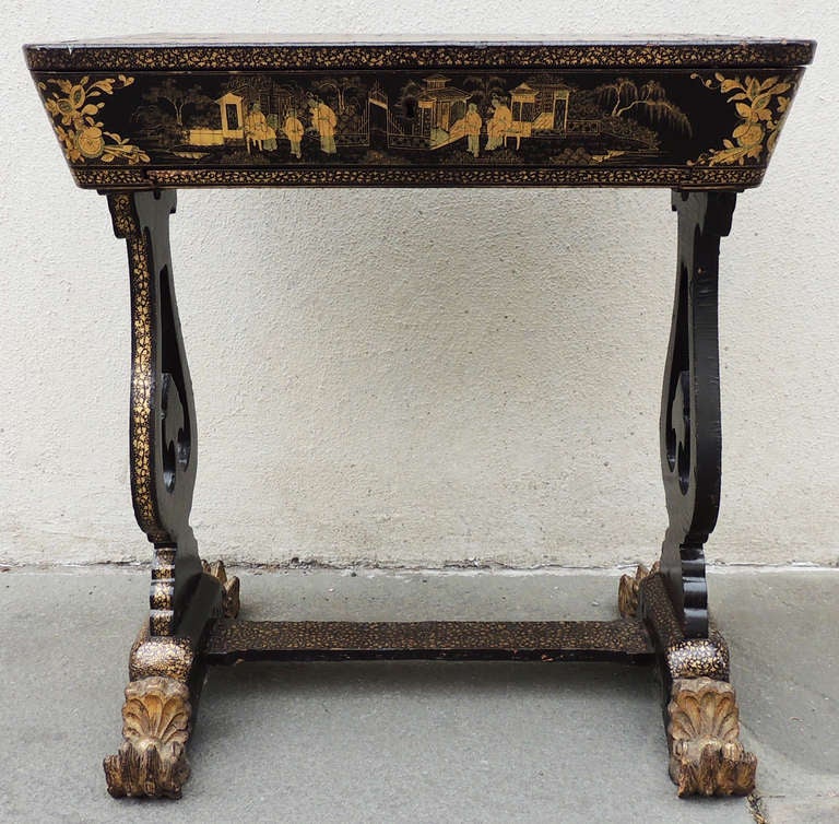 A beautiful 1830s Chinese sewing table. This piece features wonderful painted scenes and beautiful patterned legs. The top opens to reveal assorted compartments. A basket frame pulls out from
underneath the table; while it lacks upholstery, it has