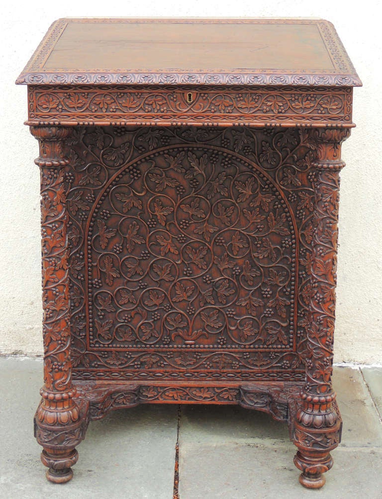 This is a truly beautiful piece. Rosewood is perfectly carved to create an enchanting and functional Davenport writing desk. A leather top lifts revealing a storage space complete with drawers. Remove the nob of one of the drawers, and a side drawer