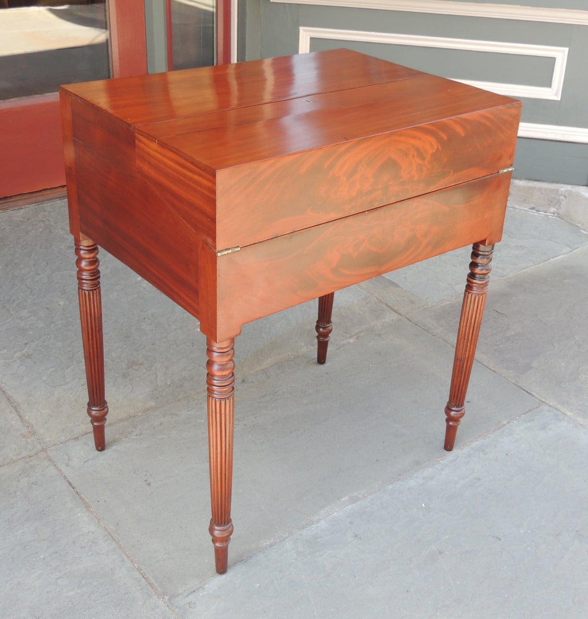 This Campaign desk was made in Virginia in the 1780s. It is made of mahogany with white oak and poplar secondary woods. This desk has a hinge top that unfolds into a desk and two panels on the writing surface that lift to reveal more storage. The