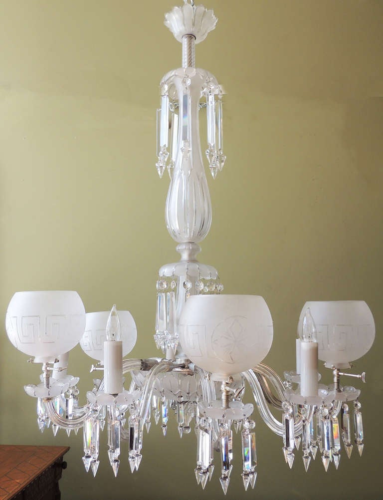 A wonderful American crystal gasolier from the 1850s. This piece features eight arms, frosted globes adorn every other light, and beautiful frosted and clear crystal pieces are features throughout. Wonderful bobeches hold elegant frog drop prisms.   