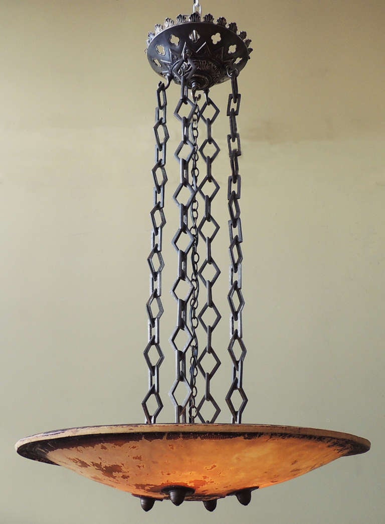 This piece is unlike anything else. Truly one of a kind, this vellum shield (with attribution and dates signed inside) makes for a beautiful chandelier. Bronze chain and canopy creates a beautiful combination of colors and materials. 20th century