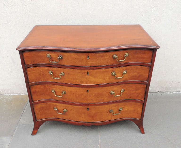 This piece was made in England, circa 1780. This piece is made of mahogany veneer and has four drawers with its original pulls and French feet.